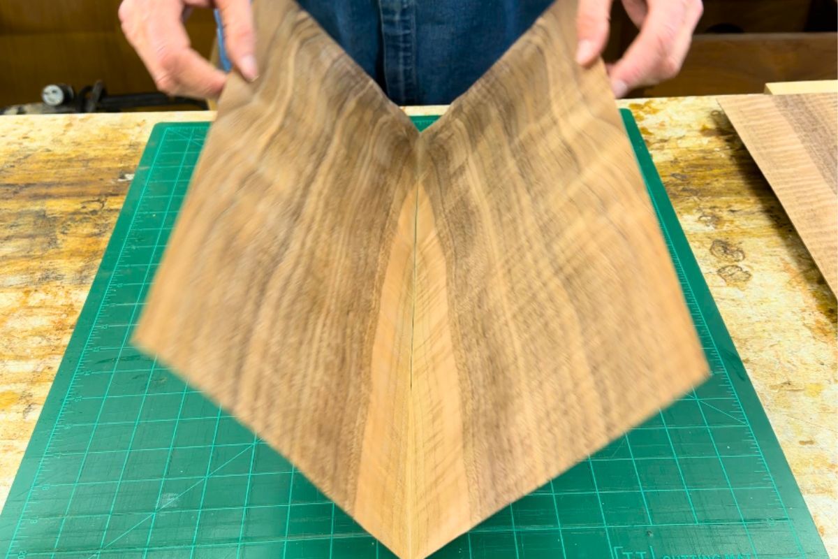 Bookmatched Fiddleback Walnut veneer prepared for a handcrafted cajon faceplate in the Kopf Percussion workshop