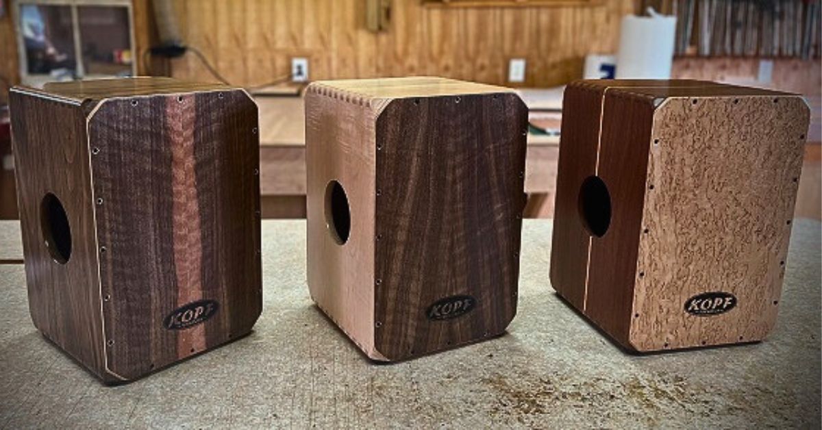 Lineup of Cajons in walnut, maple, and cherry showing the tonal variety of handcrafted Cajons.