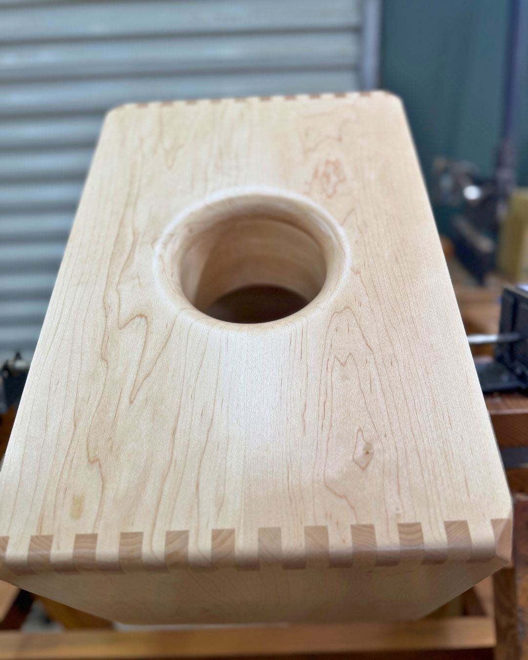 Handcrafted maple cajon body with bass port during the build process