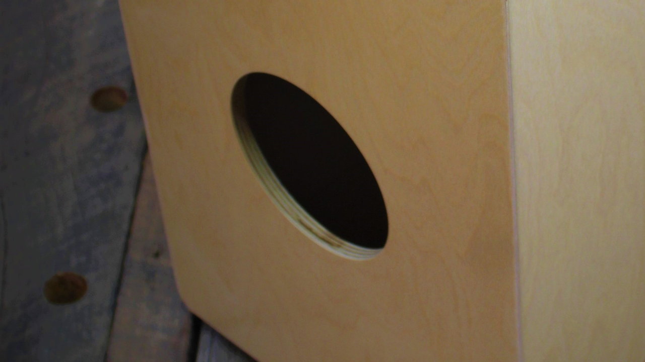  Close-up of the Novato cajon’s side sound hole, designed to deepen resonance and enhance bass tones.