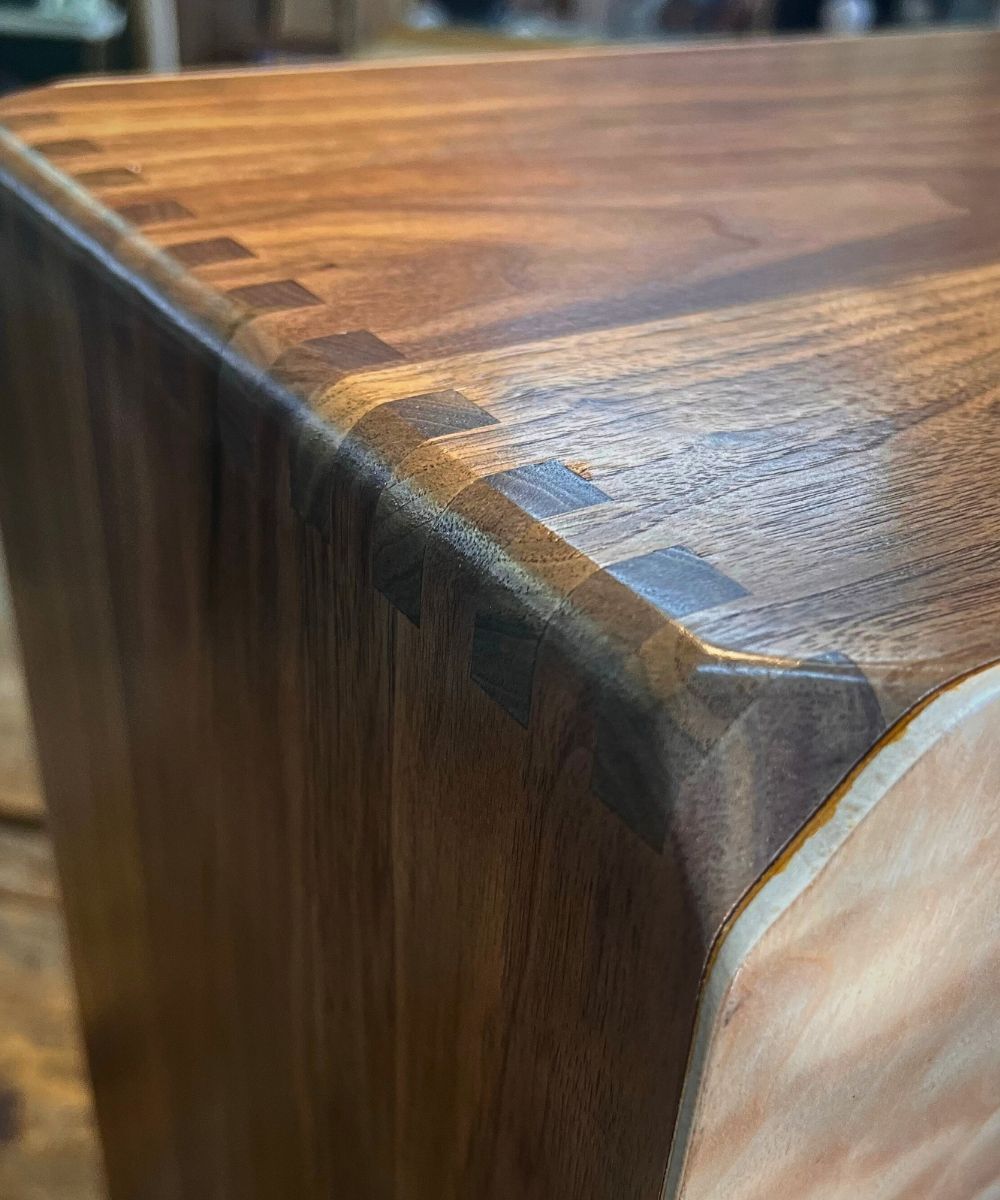 Close-up of walnut Cajon tonewood grain, showing rich chocolate brown figuring and natural beauty.